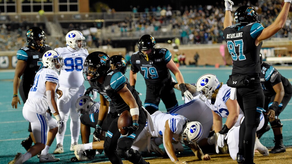 Coastal Carolina's Reese White, center, scores a touchdown during the first half of an NCAA college football game against BYU Saturday, Dec. 5, 2020, in Conway, S.C. (AP Photo/Richard Shiro)