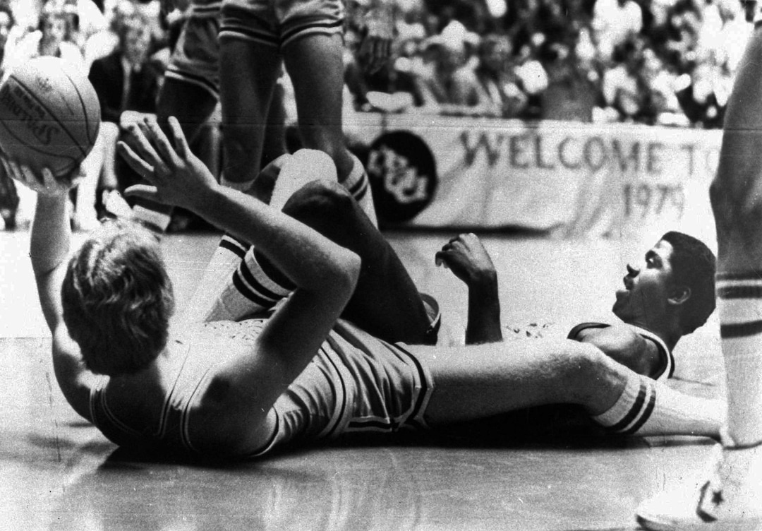 (AP Photo) Indiana State's Larry Bird, left, lies on his back to toss the ball during a scramble with Earvin "Magic" Johnson of Michigan State, right, during the NCAA Championship game in Salt Lake City, Utah, March 26, 1979.  