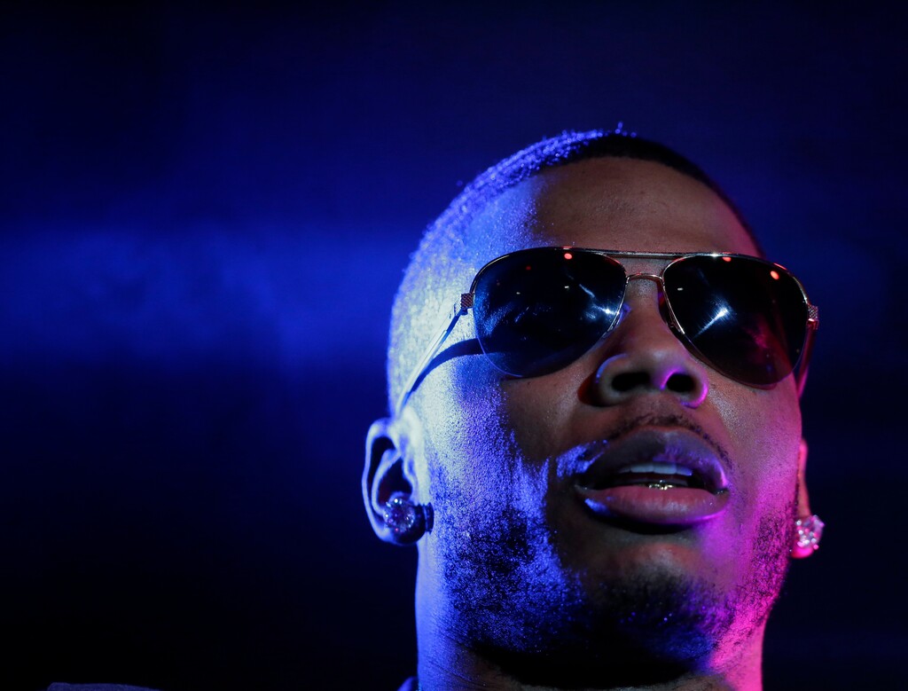 FILe - In this April 18, 2015 file photo, rapper Nelly preforms on stage during a Corner Block Party concert at Auburn University in Auburn, Ala. Police have arrested rapper Nelly after a woman said he raped her in a town outside Seattle, an accusation the Grammy winner's attorney staunchly denies. Auburn police spokesman Commander Steve Stocker said officers arrested Nelly, whose real name is Cornell Iral Haynes Jr., early Saturday, Oct. 17, 2017  in his tour bus at a Walmart.  (AP Photo/Brynn Anderson, File)