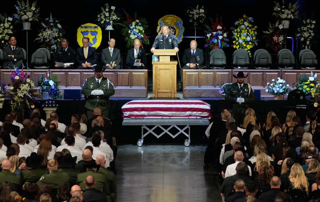 (Francisco Kjolseth  |  The Salt Lake Tribune) Santaquin police Lt. Mike Wall speaks during funeral services for Santaquin police Sgt. Bill Hooser at the UCCU Center at Utah Valley University on Monday, May 13, 2024.