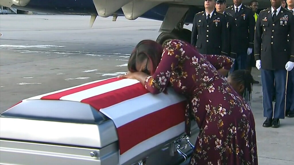 In this Tuesday, Oct. 17, 2017, frame from video, Myeshia Johnson cries over the casket in Miami of her husband, Sgt. La David Johnson, who was killed in an ambush in Niger. President Donald Trump told the widow that her husband "knew what he signed up for," according to Rep. Frederica Wilson who said she heard part of the conversation on speakerphone. (WPLG via AP)