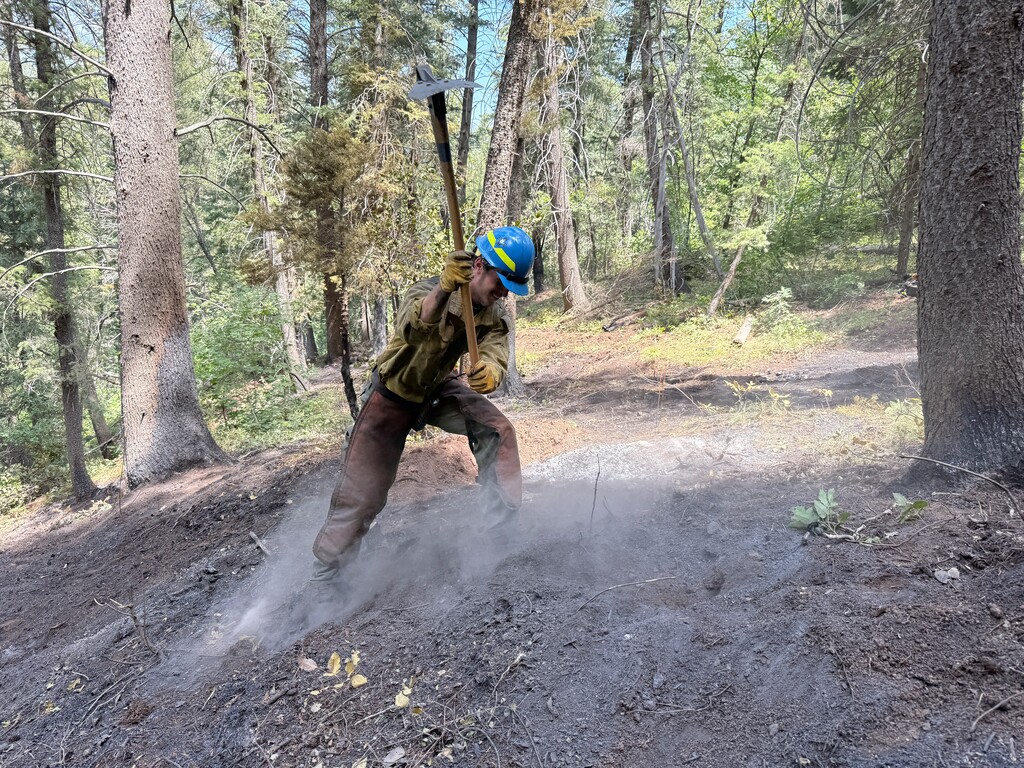 (Toby Weed | U.S. Forest Service) A U.S. Forest Service firefighter works to put out a flare-up of a fire that began on the east side of Tibble Fork Reservoir in American Fork Canyon on Aug. 4, 2025, burning a quarter-acre and prompted nearby evacuations and road closures. 