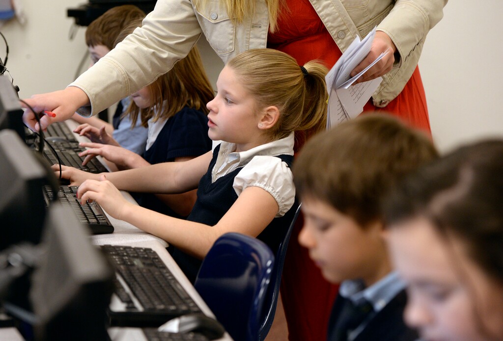 Al Hartmann  |  The Salt Lake TribuneFourth grade students at Legacy Preparatory Academy in North Salt Lake work in the computer lab on writing assignments.  Charter schools are funded through a complex blend of state and local dollars that puts charters at odds with traditional district schools. As charter schools have grown, lawmakers are reexamining the state's funding formulas. 