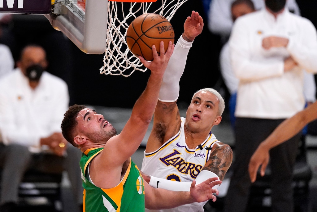 Utah Jazz forward Georges Niang, left, shoots as Los Angeles Lakers forward Kyle Kuzma defends during the first half of an NBA basketball game Saturday, April 17, 2021, in Los Angeles. (AP Photo/Mark J. Terrill)
