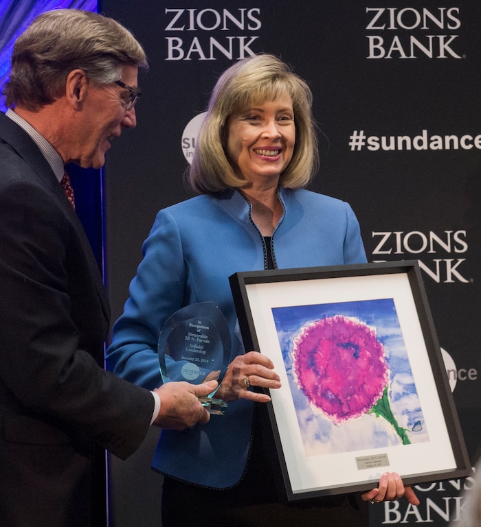 (Rick Egan  |  The Salt Lake Tribune)    Honorable Jill Parrish, Utah Supreme Court Justice, receives a leadership award from Scott Anderson, president and CEO of Zions Bank, at the 2018 Sundance Film Festival Utah Women’s Leadership Celebration in Park City on Thursday, Jan. 25, 2018.