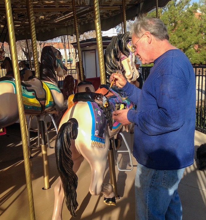 (Miken Larson) Ron Larsen paints a horse on the carousel at Town Square Park in St. George in 2016.