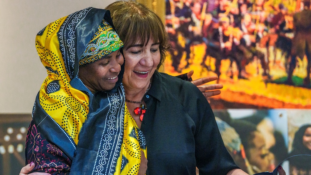 (Leah Hogsten | The Salt Lake Tribune) Samira Harnish executive director of Women of the World, right, awards Fahmo Hamadi Abdullahiw the Women of the World's 2022 Mother of the Year. Women of the World celebrates the traditions, food and stories of refugee mothers in a special MotherÕs Day event, Saturday, May 7, 2022.