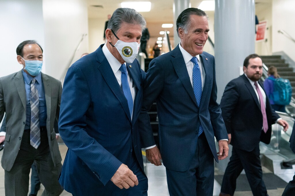 (Carolyn Kaster | AP) Sen. Joe Manchin, D-WVa., second from left, and Sen. Mitt Romney, R-Utah, walk together on Capitol Hill in Washington, Thursday, Nov. 4, 2021.