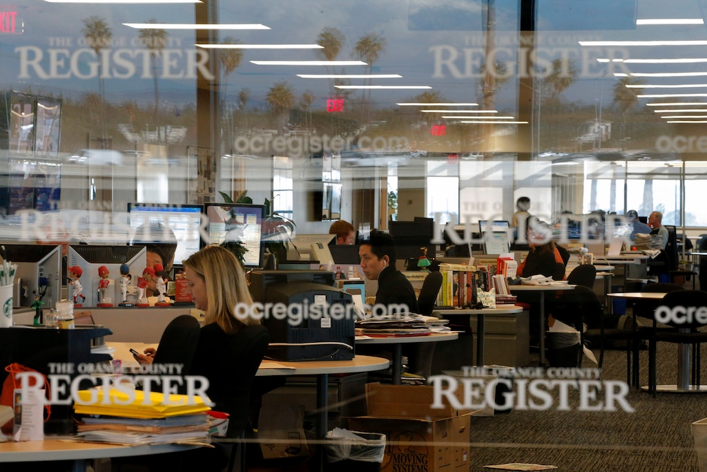 FILE - This Dec. 27, 2012 file photo shows the newsroom of the Orange County Register in Santa Ana, Calif. Tribune Publishing said Thursday, March 17, it placed the winning bid at an auction of the Southern California suburban newspapers owned by bankrupt Freedom Communications. The company said it agreed to pay $56 million for the business of Freedom, the Orange County Register and the Press-Enterprise. (AP Photo/Jae C. Hong,File)