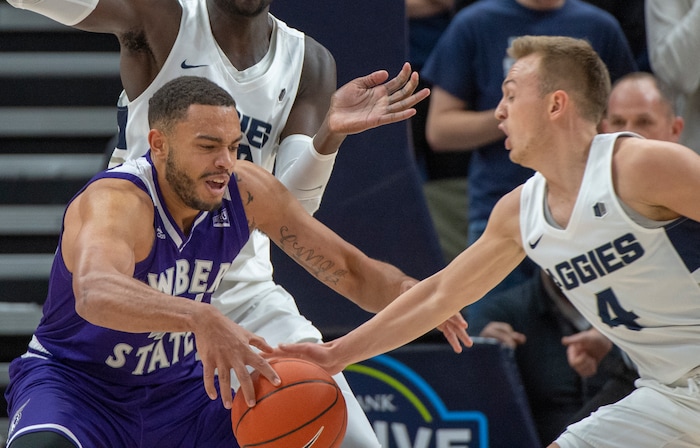 (Rick Egan  |  The Salt Lake Tribune)      Utah State Aggies guard Crew Ainge (4) steals the ball from Weber State Wildcats center Zach Braxton (44), in basketball acton in the Beehive Classic, between against the Utah State Aggies and Weber State Wildcats, a the Vivint Smart Home Arena, Saturday December 8, 2018.

 