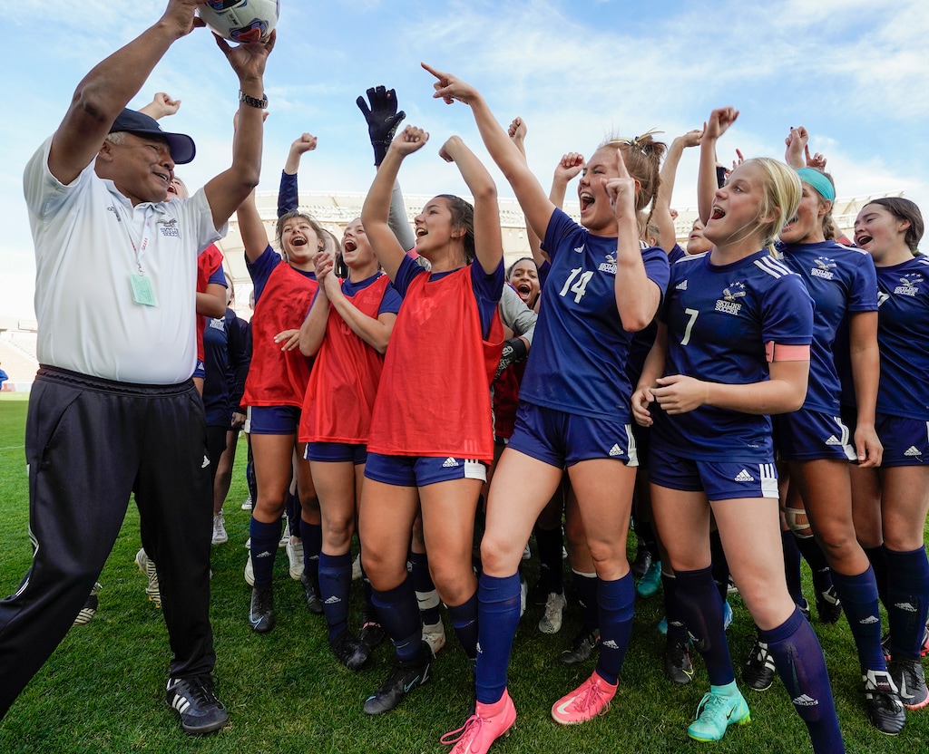 (Leah Hogsten | The Salt Lake Tribune) Skyline head coach Yamil Castillo celebrates with his players after the Eagles defeated Lehi High School, 3-1 to win the 5A Championship title Oct. 22, 2021 at Rio Tinto Stadium. 