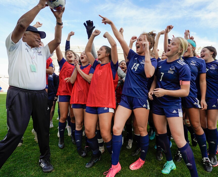 (Leah Hogsten | The Salt Lake Tribune) Skyline head coach Yamil Castillo celebrates with his players after the Eagles defeated Lehi High School, 3-1 to win the 5A Championship title Oct. 22, 2021 at Rio Tinto Stadium. 