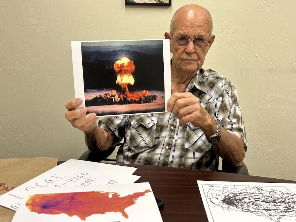 (E. George Goold | St. George News) Author Eddie "Mac" Jones shows a picture of an example of the mushroom clouds he used to see while working at Area 12 when he was a young man in Nevada, St. George, Utah, June 5, 2025.