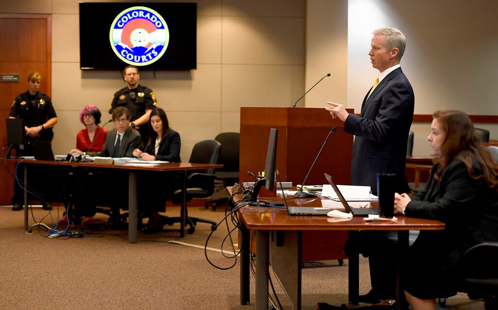 Joe Amon | The Denver Post via AP) District Attorney George Brauchler addresses the court as Devon Erickson, second from left, appears at the Douglas County Courthouse on Wednesday, May 15, 2019, in Castle Rock, Colo. Erickson is one of two students suspected of shooting several classmates in their Colorado charter school.