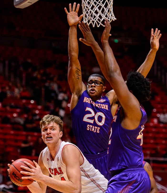 (Trent Nelson | The Salt Lake Tribune)  Utah Utes forward Jayce Johnson (34) defended by Northwestern State Demons forward Ishmael Lane (20) and Northwestern State Demons center Larry Owens (42) as the University of Utah hosts Northwestern State, NCAA basketball in Salt Lake City, Wednesday December 20, 2017.