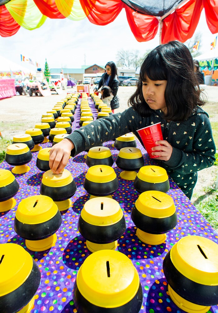 (Rick Egan  |  The Salt Lake Tribune)     Jawmarana Trai 8, puts money in the bank for the monks,  during the Wat Lao Salt Lake Buddharam Utah, New Year Celebration, in West Valley City, Sunday, April 28, 2019.


