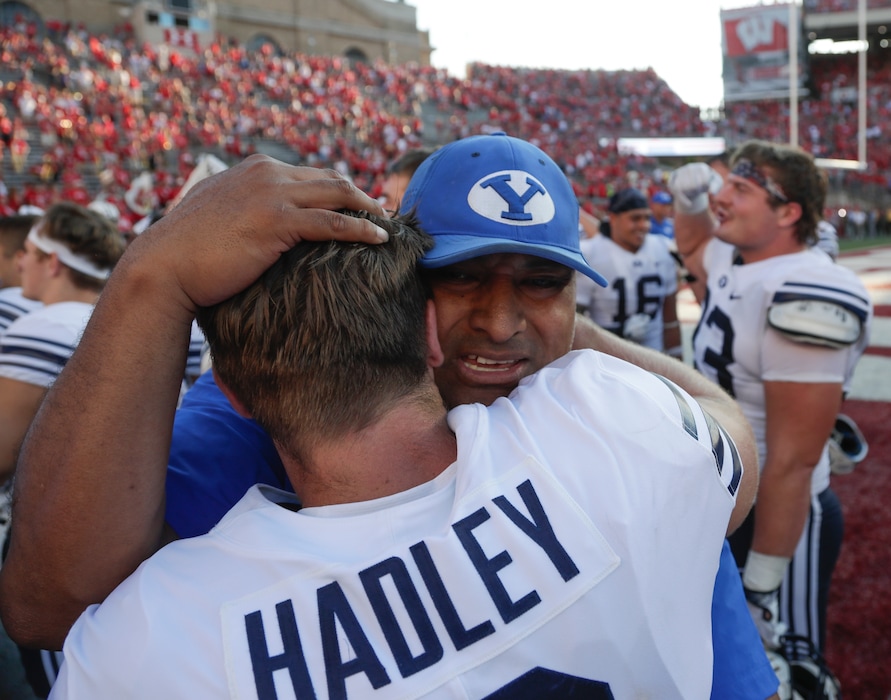 BYU head coach Kalani Sitake celebrates with Matt Hadley after an NCAA college football game against Wisconsin Saturday, Sept. 15, 2018, in Madison, Wis. BYU won 24-21. (AP Photo/Morry Gash)