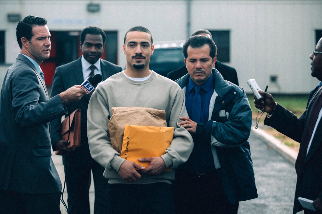 This image released by Netflix shows Freddy Miyares as adult Raymond Santana Jr. and John Leguizamo as Raymond Santana Sr., right, in a scene from "When They See Us." (Atsushi Nishijima/Netflix via AP)