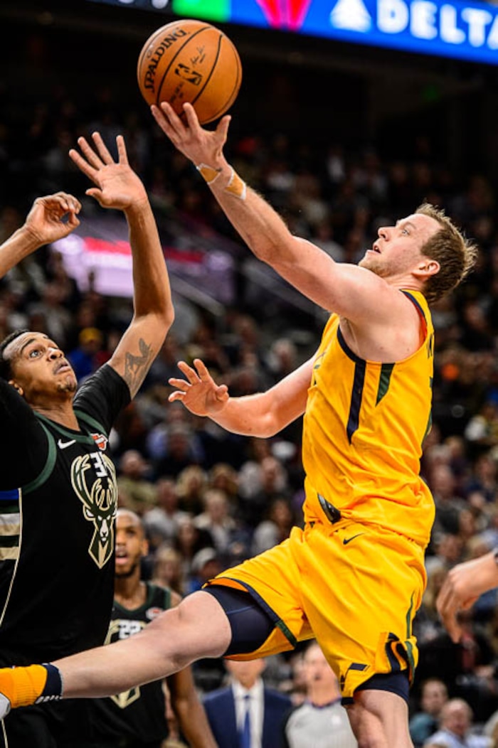 (Trent Nelson | The Salt Lake Tribune)  Utah Jazz forward Joe Ingles (2) puts a shot up over Milwaukee Bucks forward John Henson (31) as the Utah Jazz host the Milwaukee Bucks, NBA basketball in Salt Lake City Saturday November 25, 2017.