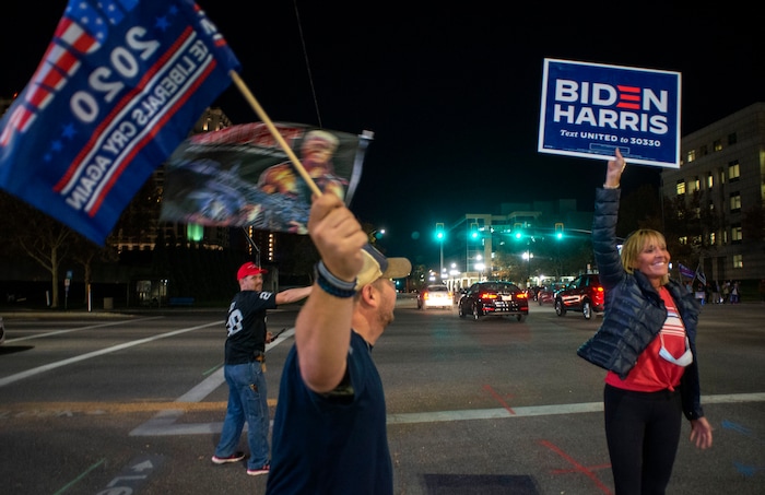 (Rick Egan | The Salt Lake Tribune)  A lone Biden supporter braves comments from Trump fans during a Trump rally at Washington Square, on Monday, Nov. 2, 2020.