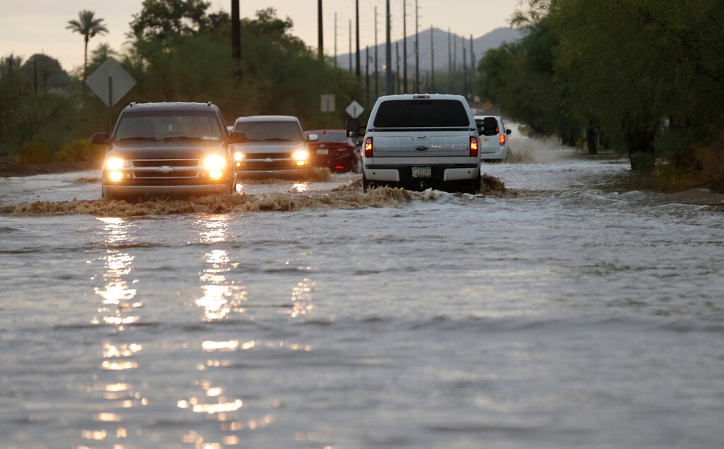 (Ross D. Franklin | AP file photo) Vehicles navigate a flooded street due to severe monsoon storms moving through the metro area Monday, July 9, 2018, in Phoenix. Cities across the Southwest have experienced little or no rainfall during the monsoon season, which runs from June through September.