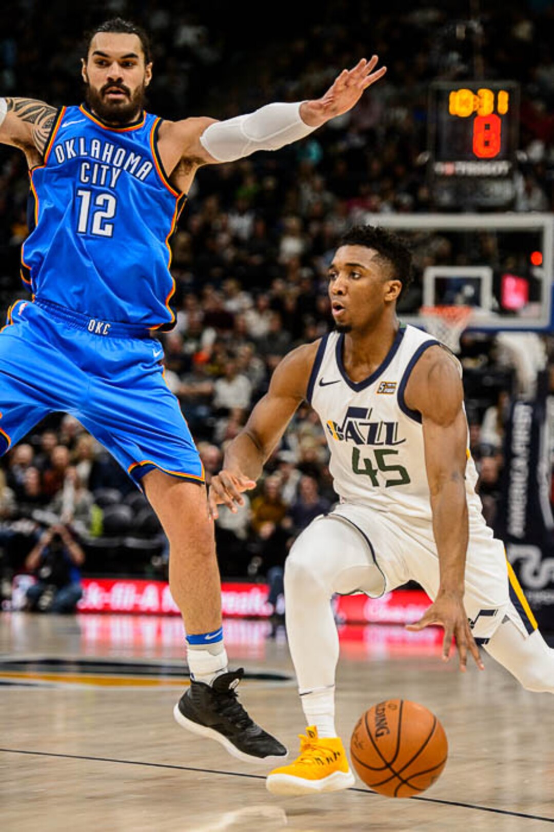 (Trent Nelson | The Salt Lake Tribune)  Utah Jazz guard Donovan Mitchell (45) defended by Oklahoma City Thunder center Steven Adams (12) as the Utah Jazz host the Oklahoma City Thunder, NBA basketball in Salt Lake City, Saturday December 23, 2017.