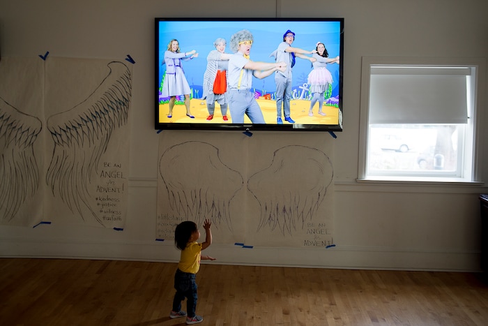 (Jeremy Harmon  |  The Salt Lake Tribune) Seventeen-month-old Bella dances along with a "baby shark" video as she plays inside the First Unitarian Church on 1300 East in Salt Lake City on Dec. 14, 2018.