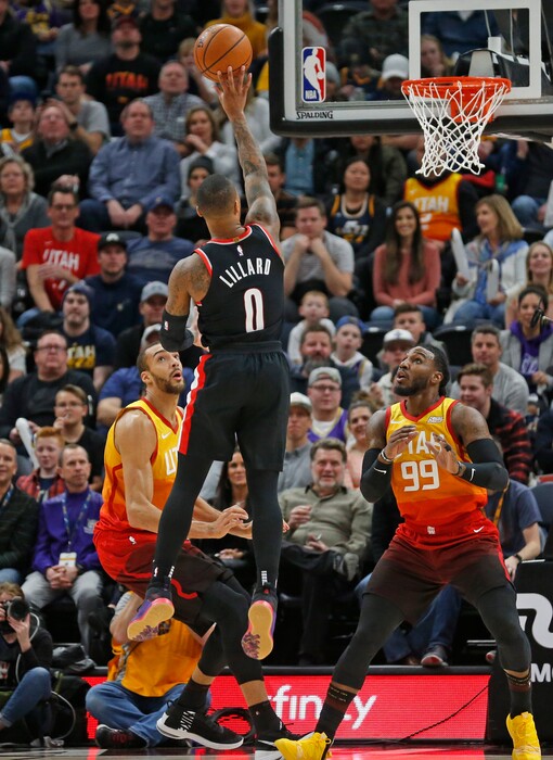 Portland Trail Blazers guard Damian Lillard (0) shoots as Utah Jazz's Rudy Gobert (27) and Jae Crowder (99) look on during the first half in an NBA basketball game Monday, Jan. 21, 2019, in Salt lake City. (AP Photo/Rick Bowmer)