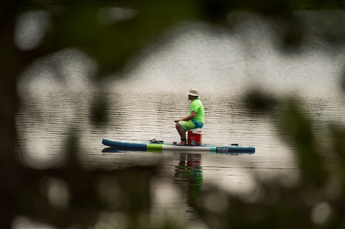 (Leah Hogsten  |  The Salt Lake Tribune)  A man fishes from his paddle board on Mirror Lake, Aug. 6, 2017.