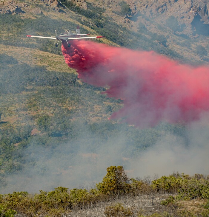 (Francisco Kjolseth  |  The Salt Lake Tribune) Fire crews battle a fire near Millcreek Canyon, on Saturday, July 11, 2020, started near 3400 South Crestwood Dr., as helicopters, single engine air tankers and multiple crews respond.