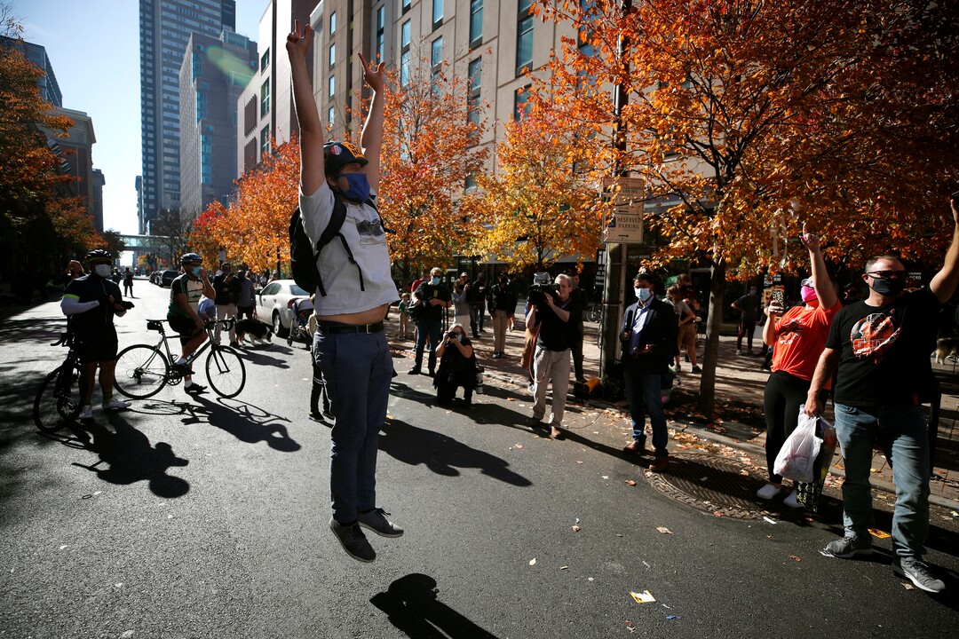 People celebrate outside the Pennsylvania Convention Center after Democrat Joe Biden defeated President Donald Trump to become 46th president of the United States, Saturday, Nov. 7, 2020, in Philadelphia. (AP Photo/Rebecca Blackwell)