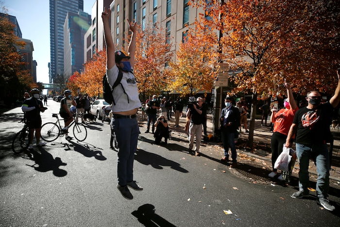 People celebrate outside the Pennsylvania Convention Center after Democrat Joe Biden defeated President Donald Trump to become 46th president of the United States, Saturday, Nov. 7, 2020, in Philadelphia. (AP Photo/Rebecca Blackwell)