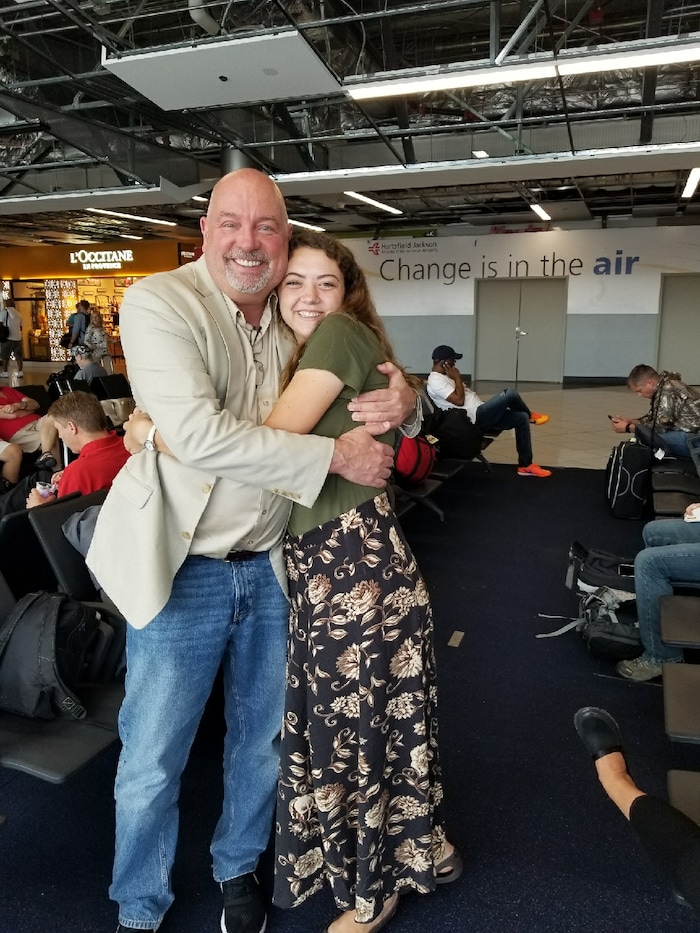 Courtesy | Michael McDonald. Mormon missionary Erin McDonald meets by chance with her parents at the Atlanta airport while evacuating from Puerto Rico on September 23, 2017.