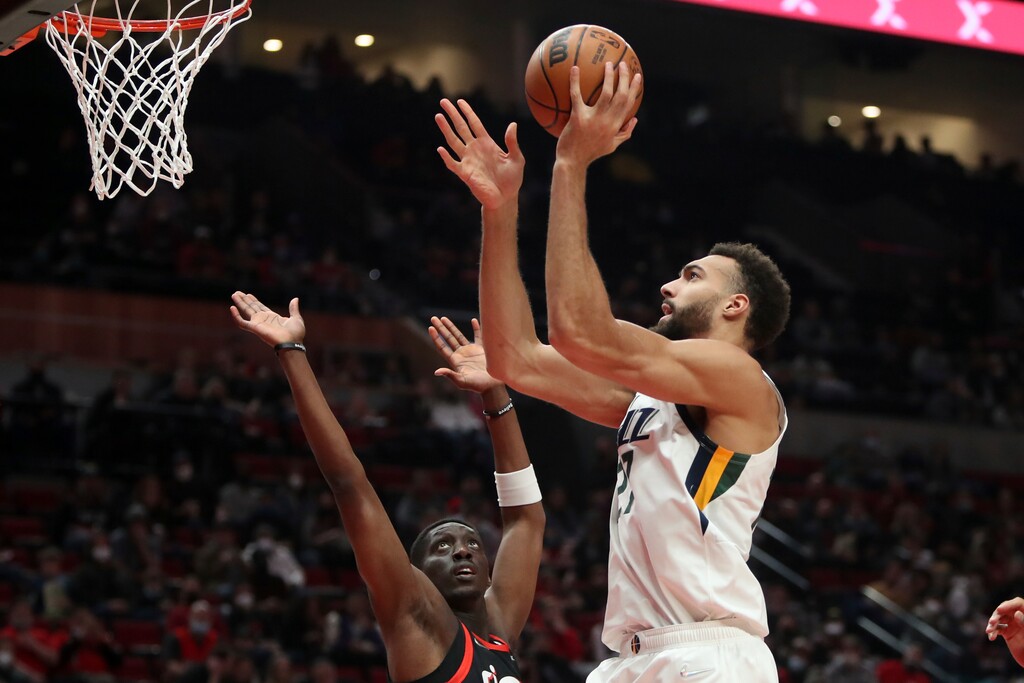 (Amanda Loman | AP) Utah Jazz center Rudy Robert shoots over Portland Trail Blazers forward Tony Snell during the first half of an NBA basketball game in Portland, Ore., Wednesday.