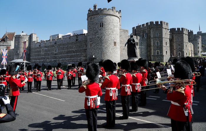 A military brass band plays outside the castle prior to the wedding ceremony of Prince Harry and Meghan Markle at St. George's Chapel in Windsor Castle in Windsor, near London, England, Saturday, May 19, 2018. (AP Photo/Frank Augstein)