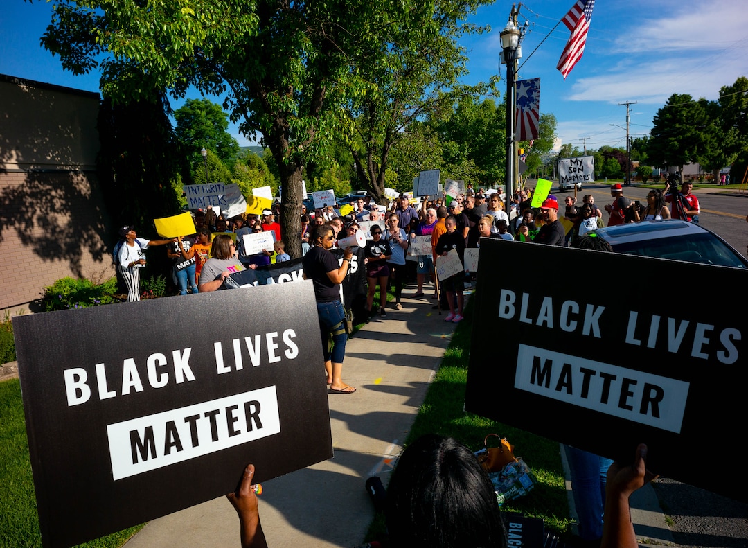 (Trent Nelson  |  The Salt Lake Tribune)Lex Scott leads chants at a protest organized by Black Lives Matter and other groups at the Woods Cross Police Department on Friday June 14, 2019. The rally was to show support for DJ Hrubes, a 10-year-old black child who was held at gunpoint by a police officer last week while playing in his grandmother's front yard.