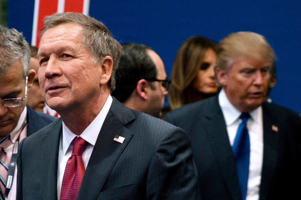 FILE - In this Feb. 6, 2016, file photo, Ohio Gov. John Kasich, left, and Donald Trump, right, speak to reporters after a Republican presidential primary debate  in Manchester, N.H.  Kasich is skipping a Republican Party fundraiser Friday, Aug. 24, 2018, where Trump is the headliner. Kasich’s decision comes as no surprise. The two are locked in a fierce and public rivalry. (AP Photo/Matt Rourke, File)