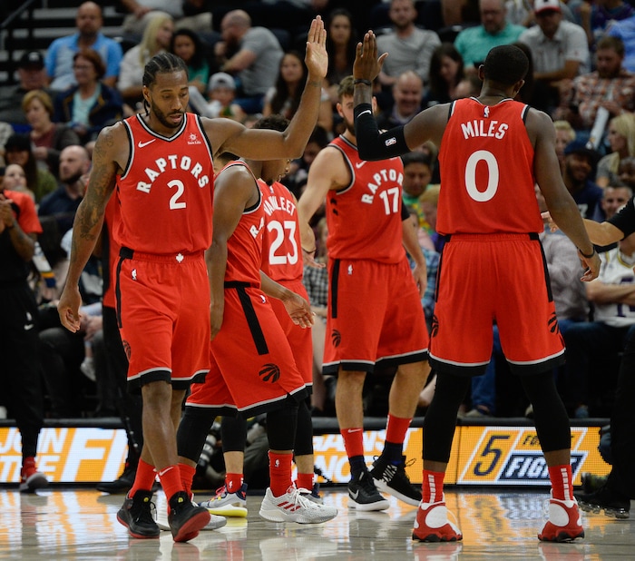 (Francisco Kjolseth  |  The Salt Lake Tribune)  Toronto Raptors forward Kawhi Leonard (2) celebrates a point with Toronto Raptors forward CJ Miles (0) in the first half of the preseason NBA game at Vivint Smart Home Arena Tuesday, Oct. 2, 2018, in Salt Lake City.