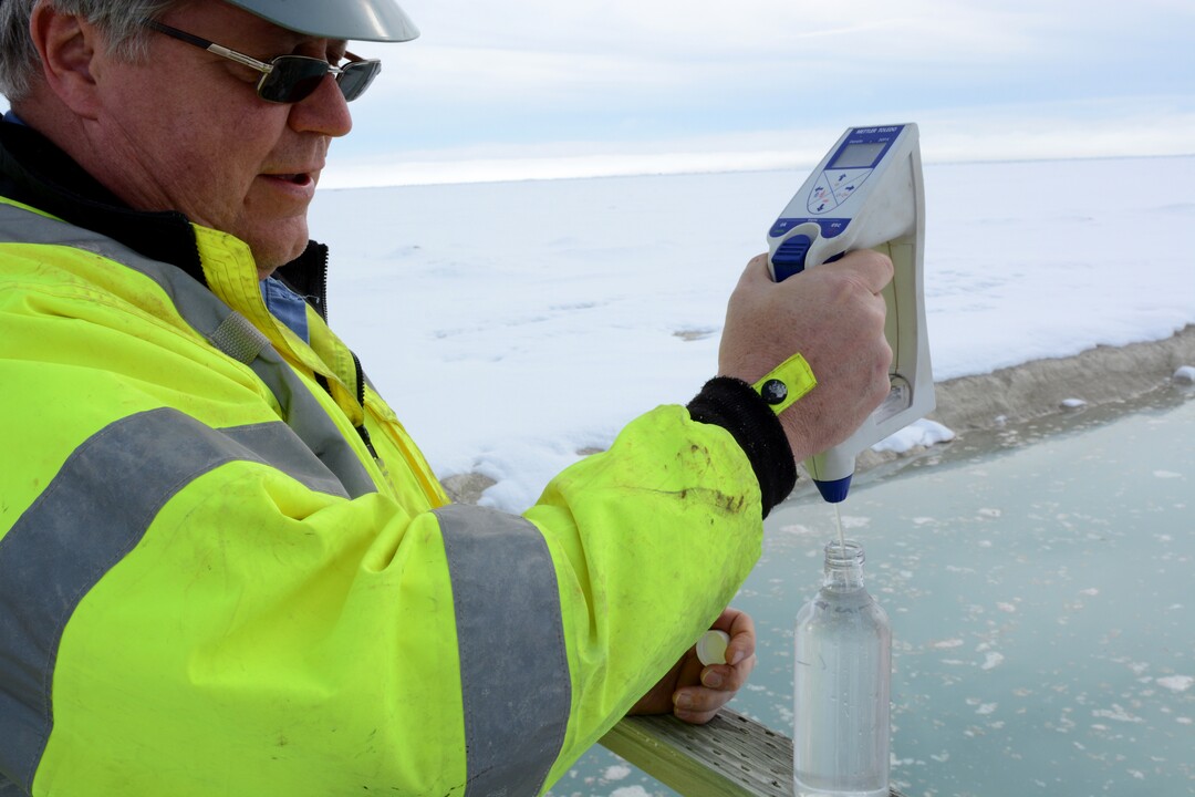 (Photo courtesy of the Bureau of Land Management) An engineer with Intrepid Potash measures the specific gravity and temperature of brine being pumped in February 2018 from Intrepid’s evaporative ponds near Wendover onto Utah’s Bonneville Salt Flats. Under a proposed $50 million program, this pumping would be substantially increased in an effort to restore the thinning halite crust on the Salt Flats, which has become so depleted that speed racing may soon come to an end on the famous playa.
