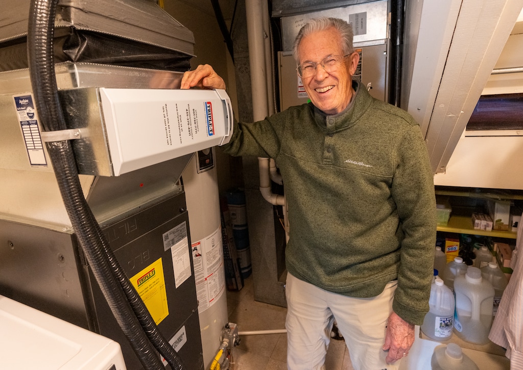 (Rick Egan | The Salt Lake Tribune) Don Jarvis with his heat pump in his home in Provo, on Thursday, April 6, 2023. Jarvis said his house got down to 4 degrees this winter but he stayed comfortable.