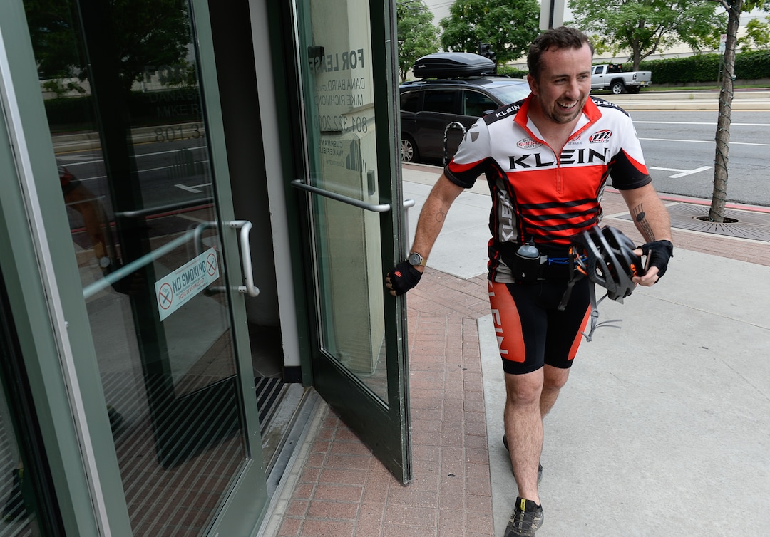 (Francisco Kjolseth  |  The Salt Lake Tribune)  Salt Lake Tribune reporter Ben Wood completes his race against colleagues during a downtown transportation race from Library Square to the Tribune building at the Gateway on Thursday, Aug. 2, 2018, after docking his Green Bike. Modes of transportation included, rentable electric scooters, Green Bike, TRAX, Lyft, and walking.