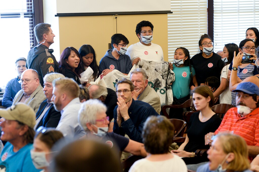 (Leah Hogsten | Tribune file photo) Opponents of the proposed inland port are escorted out of the Utah Inland Port Authority Board meeting by Utah Highway Patrol officers at the Capitol on June 5, 2019. The Inland Port Authority Board had to cancel its meeting last month after a group of protesters took over the meeting.