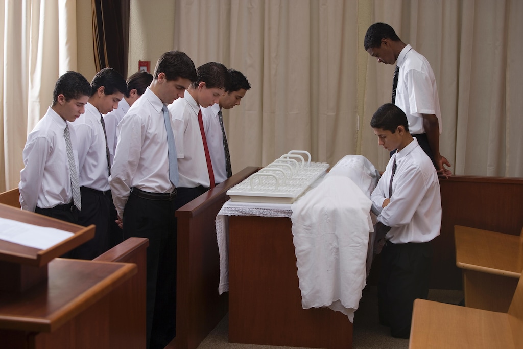 (The Church of Jesus Christ of Latter-day Saints) 
Young male Latter-day Saints administer the sacrament, or Communion. A blogger says it's past time to let girls pass the bread and water.