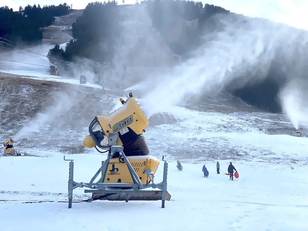 (Angus M. Thuermer Jr./WyoFile) Snowmaking machines run full-tilt on Snow King Mountain in Jackson as operators take advantage of cold temperatures Tuesday in an effort to limit the delay in opening the ski resort this season. All three Teton County resorts have put off their opening days due to a lack of snow and warm temperatures that have restricted snowmaking.
