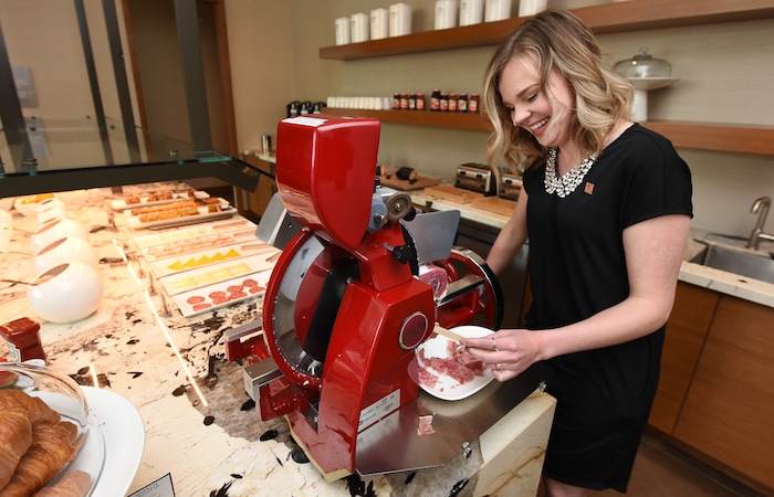 (Francisco Kjolseth  |  The Salt Lake Tribune)  Hannah Mohler, breakfast host at the new AC Hotel in Salt Lake City, uses the $10,000 Berkel prosciutto slicer to cut paper thin slices of cured meat.