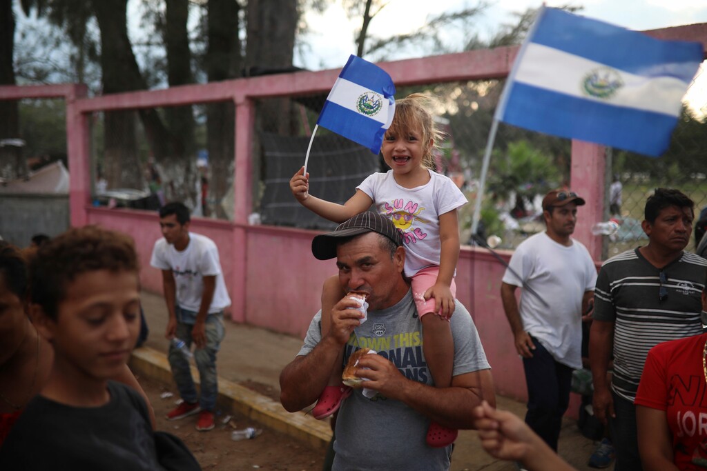 A Salvadoran girl waves her national flag as Central American migrants traveling with the annual Stations of the Cross caravan march to call for migrants' rights and protest the policies of U.S. President Donald Trump and Honduran President Juan Orlando Hernandez, in Matias Romero, Oaxaca state, Mexico, Tuesday, April 3, 2018. Bogged down by logistical problems, large numbers of children and fears about people getting sick, the caravan was always meant to draw attention to the plight of migrants and was never equipped to march all the way to the U.S. border. (AP Photo/Felix Marquez)