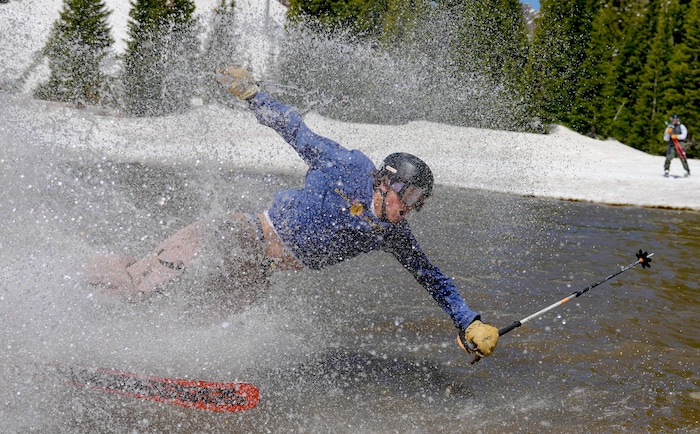 (Francisco Kjolseth  | The Salt Lake Tribune) Bill Busse takes a swim in the pond in Peruvian Gulch as Snowbird closes the book on the 2024-25 ski season on Monday, May 26, 2025. Snow and sun revelers took to the slushy slopes on Memorial Day as the resort was the last in the state to close.
