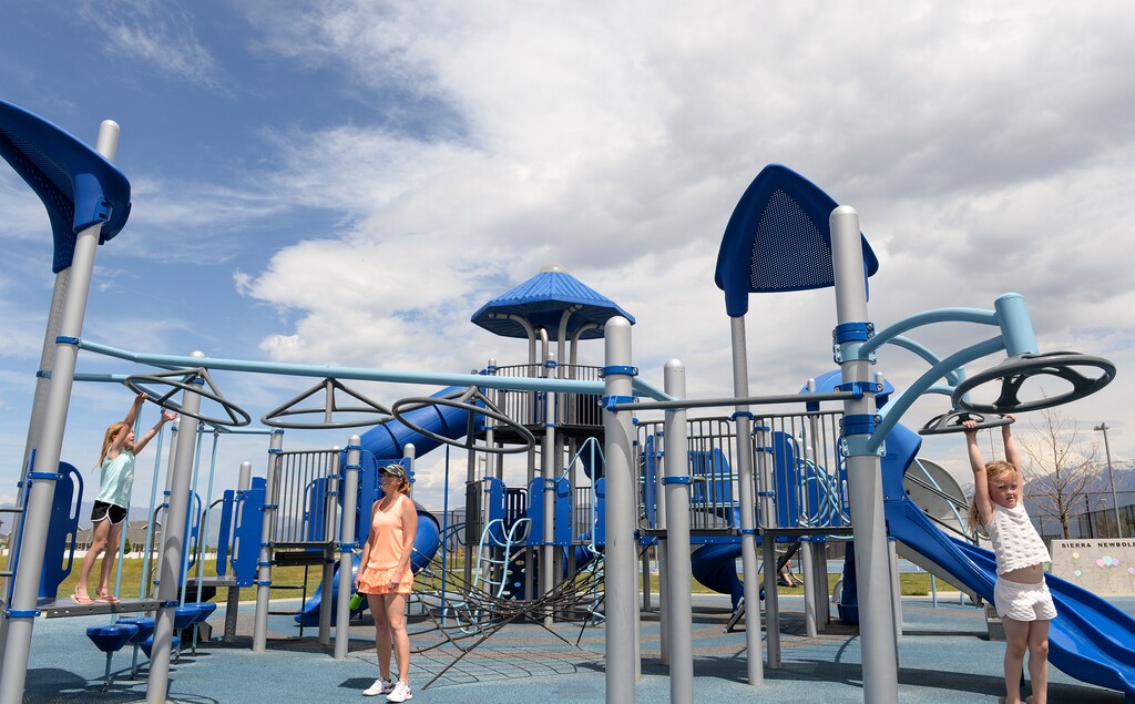 (Chris Samuels | The Salt Lake Tribune) A family plays at Sierra Newbold Memorial Playground in West Jordan, Thursday, May 26, 2022.
