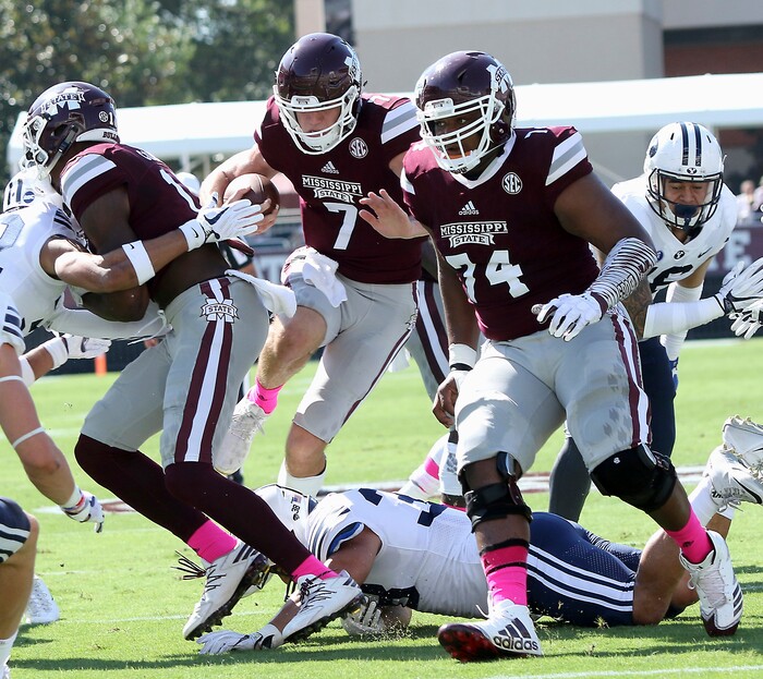 Mississippi State quarterback Nick Fitzgerald (7) leaps over a BYU defender to score a touchdown during the first half of an NCAA college football game in Starkville, Miss., Saturday, Oct. 14, 2017. (AP Photo/Jim Lytle)