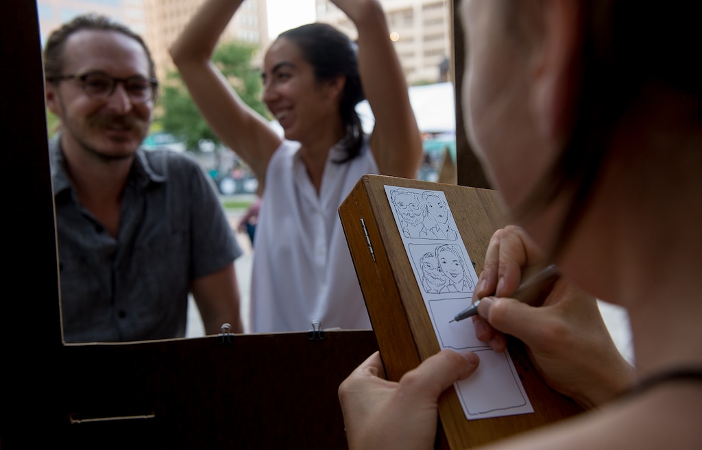 (Leah Hogsten | Tribune file photo) Natalie Allsup-Edwards, right, draws a caricature of a couple in the "Hand Drawn Photo Booth" at the 2017 Craft Lake City DIY Festival. Allsup-Edwards will be back, alongside hundreds of other artisans, for the festival's 2019 edition, Aug. 9-11, at the Utah State Fairpark.